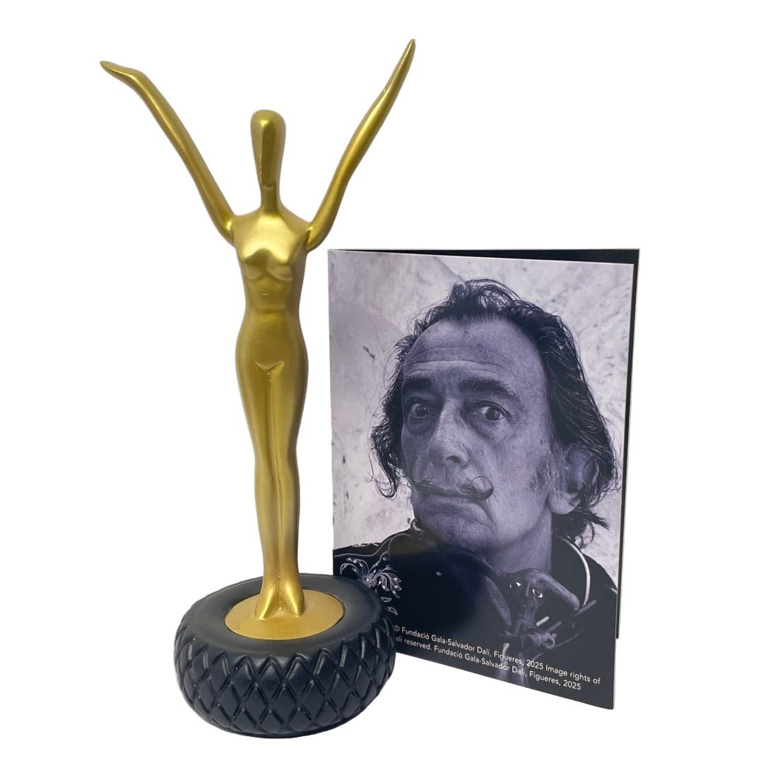 Dalí “Welcome Statue” gold resin figurine on tire base displayed with description card from Parastone Museum Collection