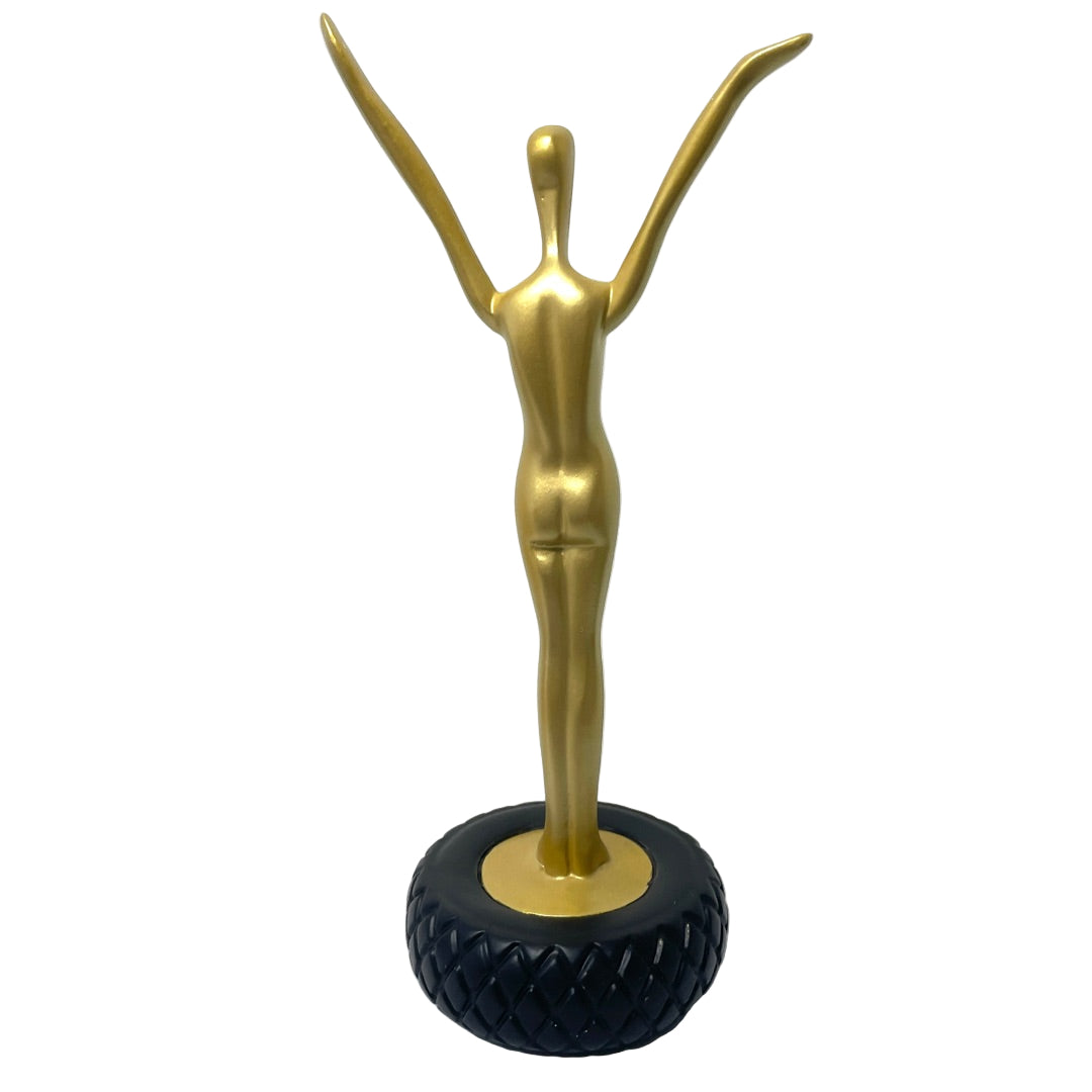 Back view of gold Dalí figurine on black base showing sculptural contours and Art Deco-inspired lines