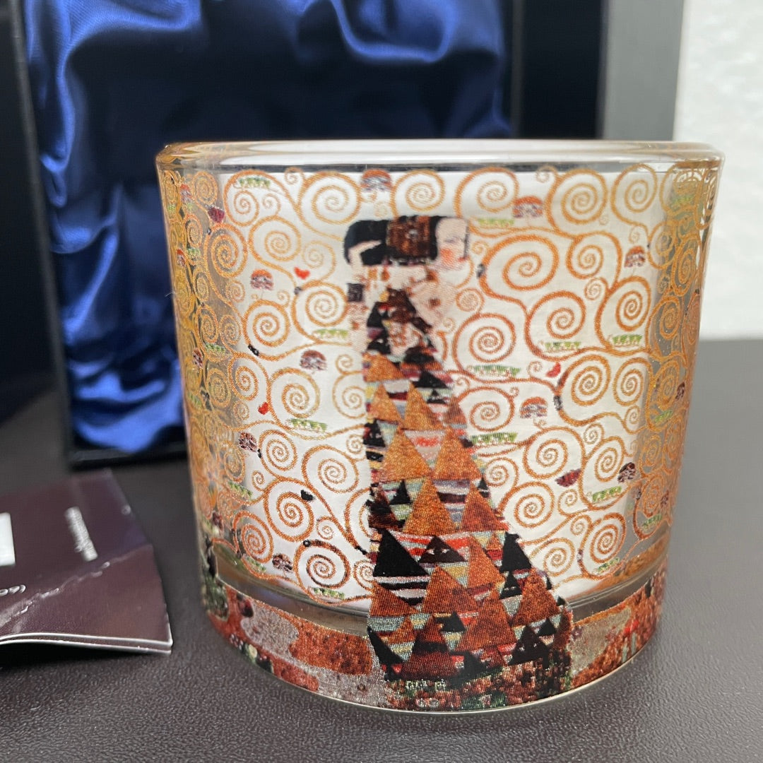 Decorative candle with artistic design on a surface