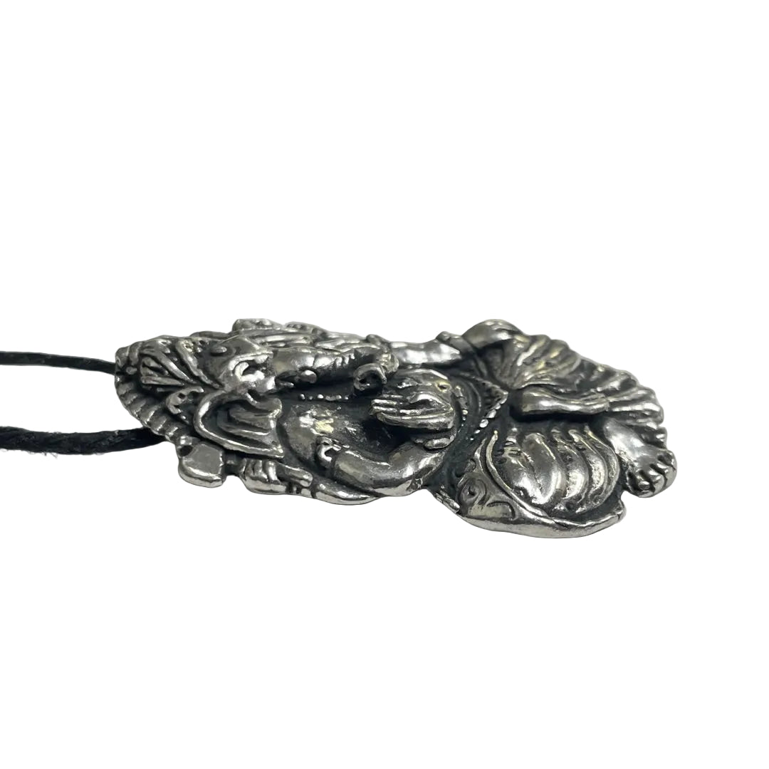 A detailed silver-toned metal pendant depicting a reclining figure with leaf-like textures, suspended on a black cord