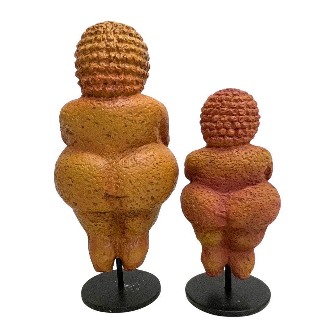 Back view of small and large Venus of Willendorf replicas inspired by the Paleolithic figure.