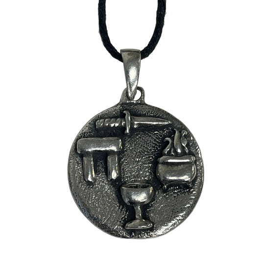 A silver-toned circular pendant necklace featuring raised symbols of the Wiccan Triple Goddess (trident, sword, chalice, and cauldron)