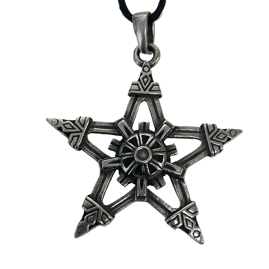 A silver-toned metal pentagram pendant with intricate geometric engravings, hanging from a black cord on a plain white background.