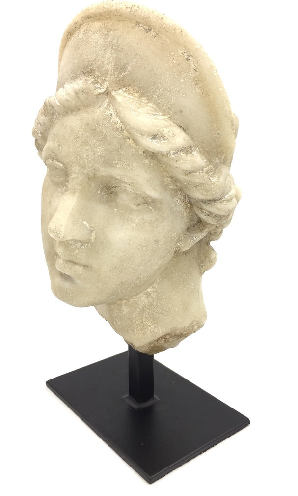 Aphrodite bust statue side profile showing classical Greek features and weathered stone texture