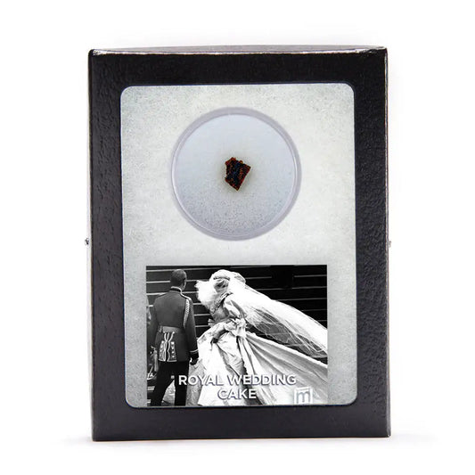 Charles Diana wedding cake fragment in sealed acrylic specimen jar, mounted in glass-topped Riker display box