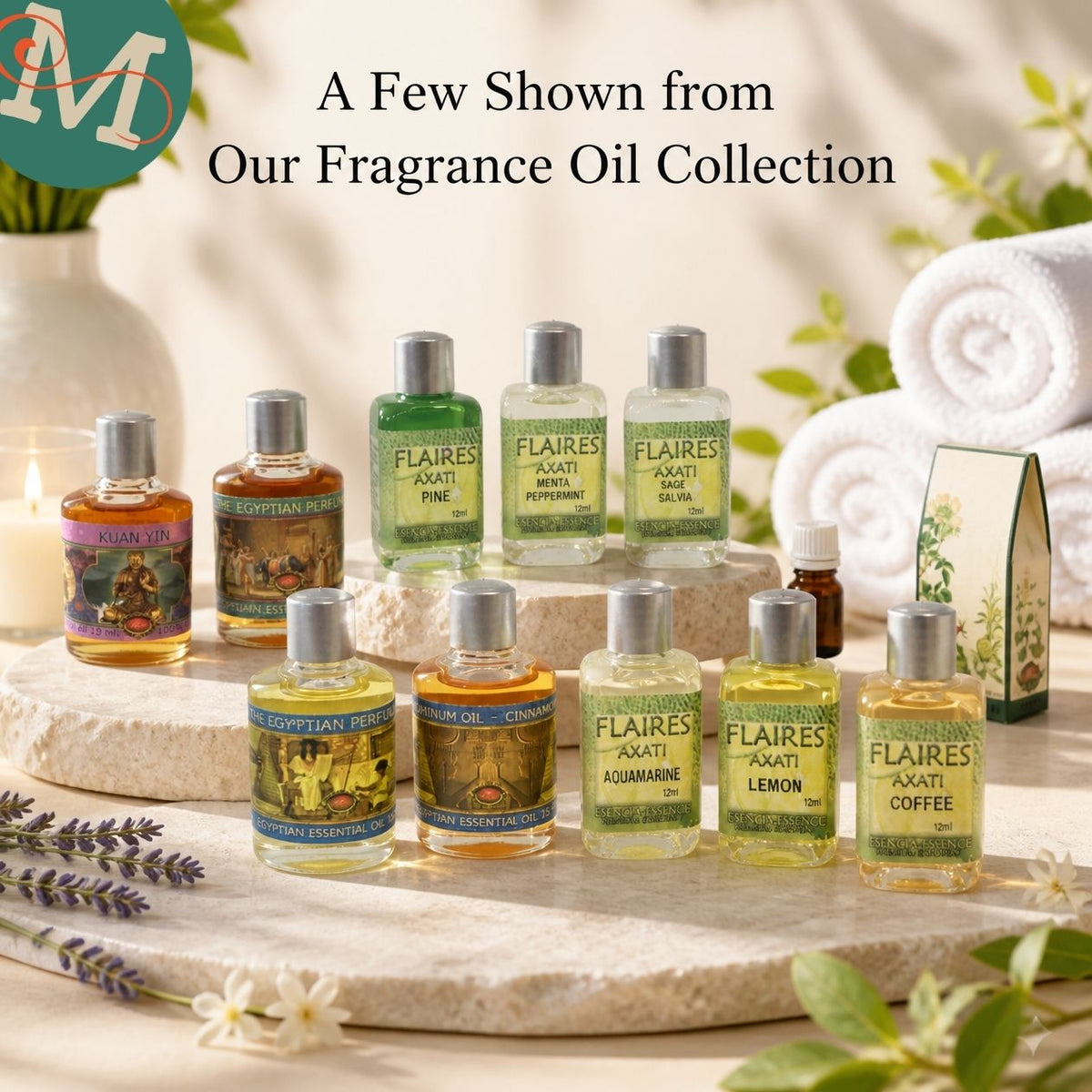 A curated display of multiple small fragrance oil bottles from the brand Flaires, arranged on stone platters with rolled white towels, lavender sprigs, and a candle in a softly lit spa-like setting. Text at the top reads, 'A Few Shown from Our Fragrance Oil Collection.